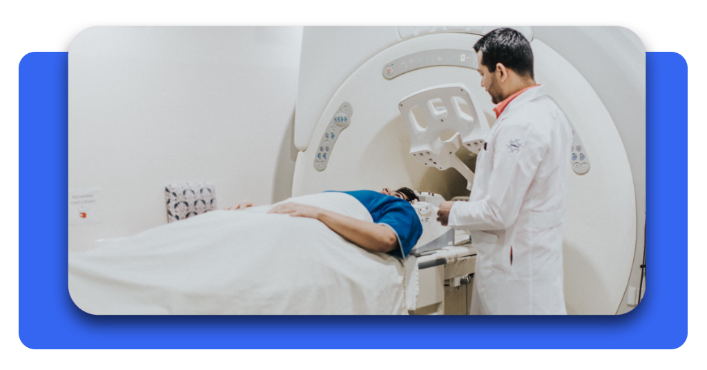 Cómo acceder a atención médica gratuita en España si no tienes seguro 7 Paciente en bata de hospital al que se le realiza un estudio de resonancia magnética de forma gratuita en España en compañía de su médico tratante.
